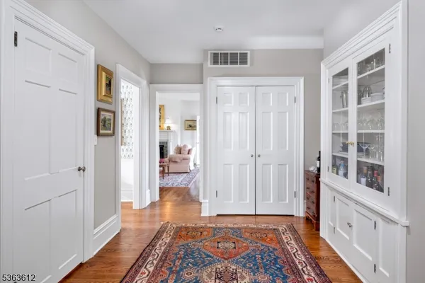 a view of a bedroom with wooden floor and windows