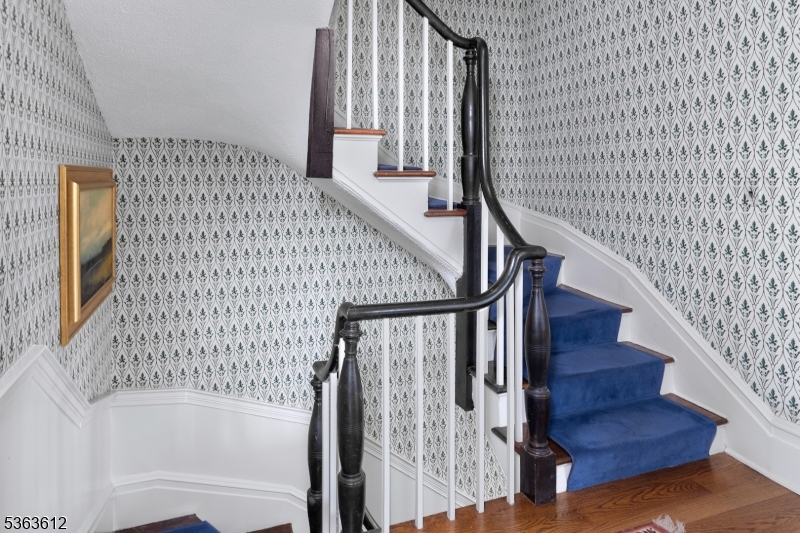 122 Bedens Brook Road Skillman, NJ 08558 - Photo 30 of 47 a view of staircase with wooden floor and white walls