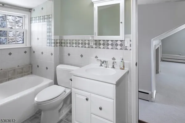 a bathroom with a sink toilet vanity and shower