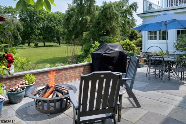 a view of a patio with furniture and a garden