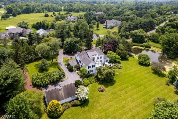 an aerial view of residential house with swimming pool and outdoor space