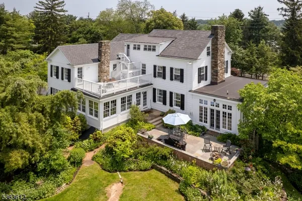 an aerial view of a house with a big yard and potted plants