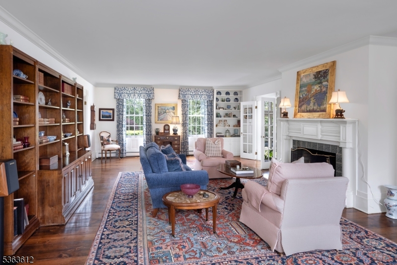 122 Bedens Brook Road Skillman, NJ 08558 - Photo 8 of 47 a living room with furniture a fireplace and a book shelf