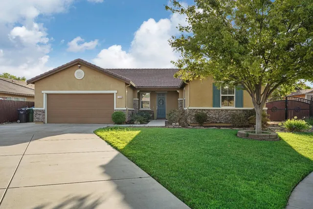 a front view of a house with garden