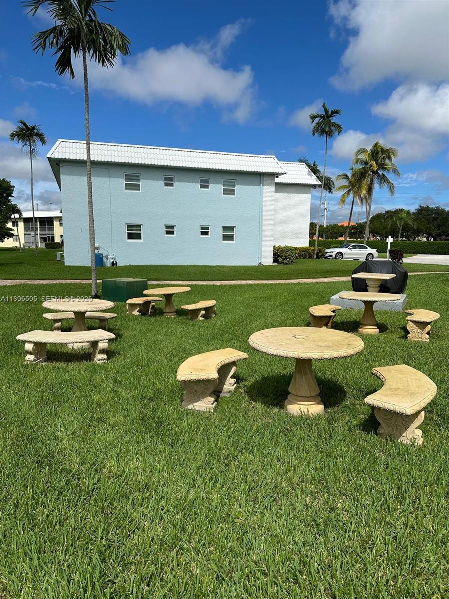 9848 Marina Boulevard, Unit 811 Boca Raton, FL 33428 - Photo 78 of 86 a view of a swimming pool with a table and chairs