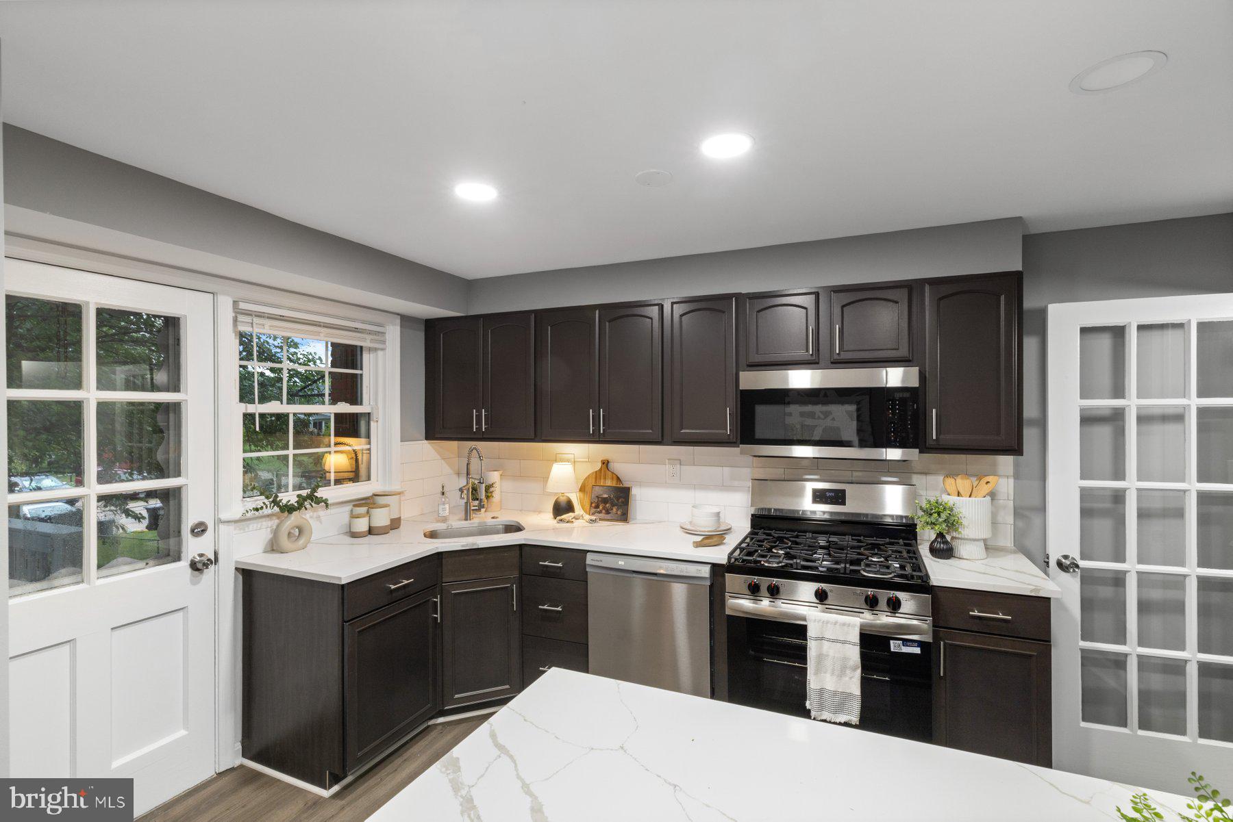 1579 Dellsway Road Towson, MD 21286 - Photo 5 of 33 a kitchen with a sink stove and microwave