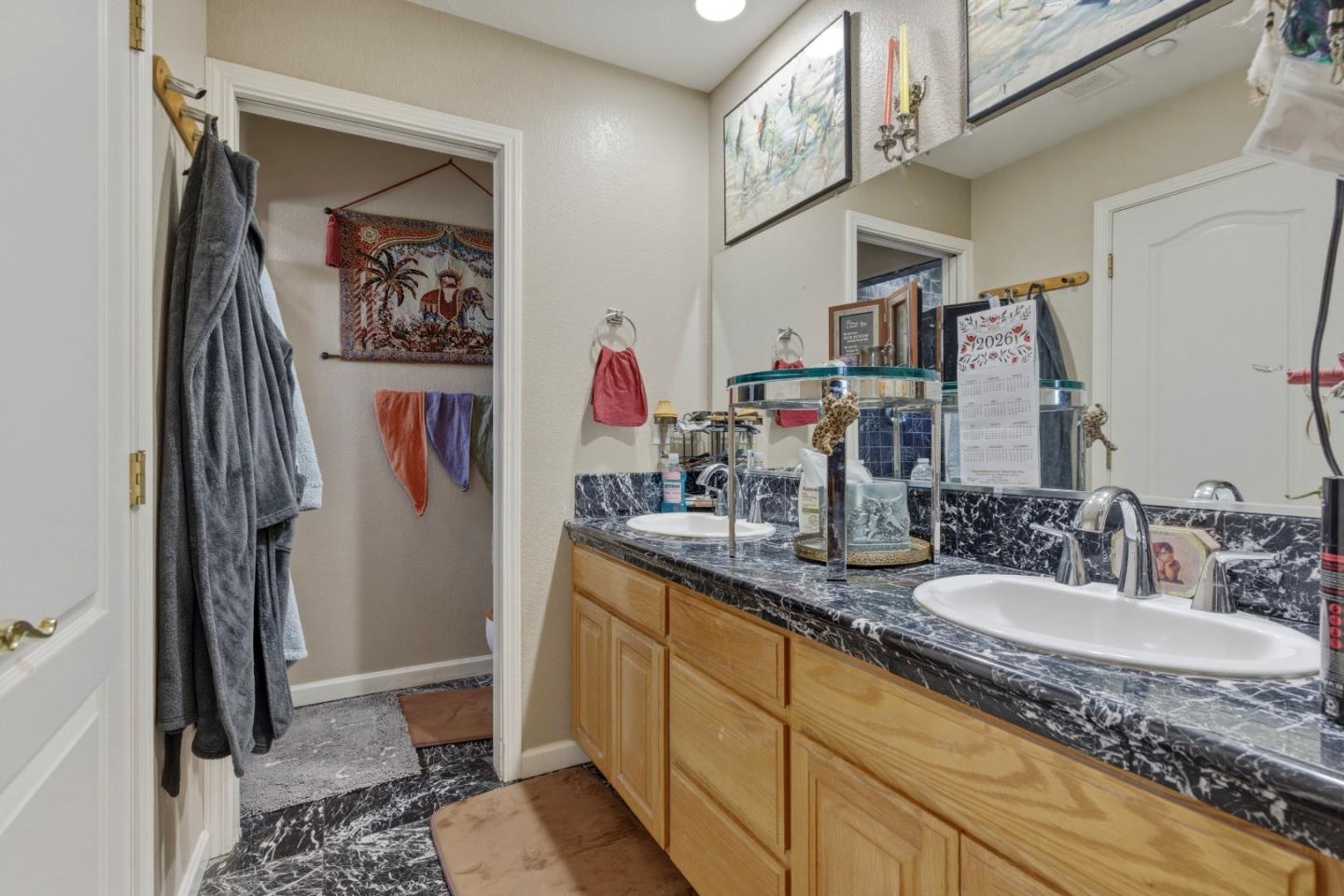 38780 Dinosaur Point Road Hollister, CA 95023 - Photo 10 of 34 a bathroom with a granite countertop sink a mirror and shower