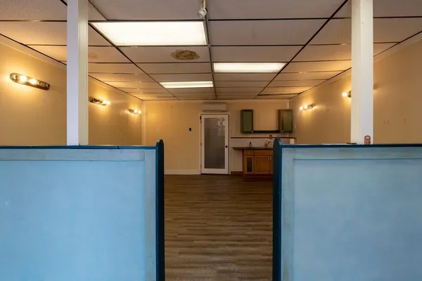 a view of a hallway with closet and bathroom