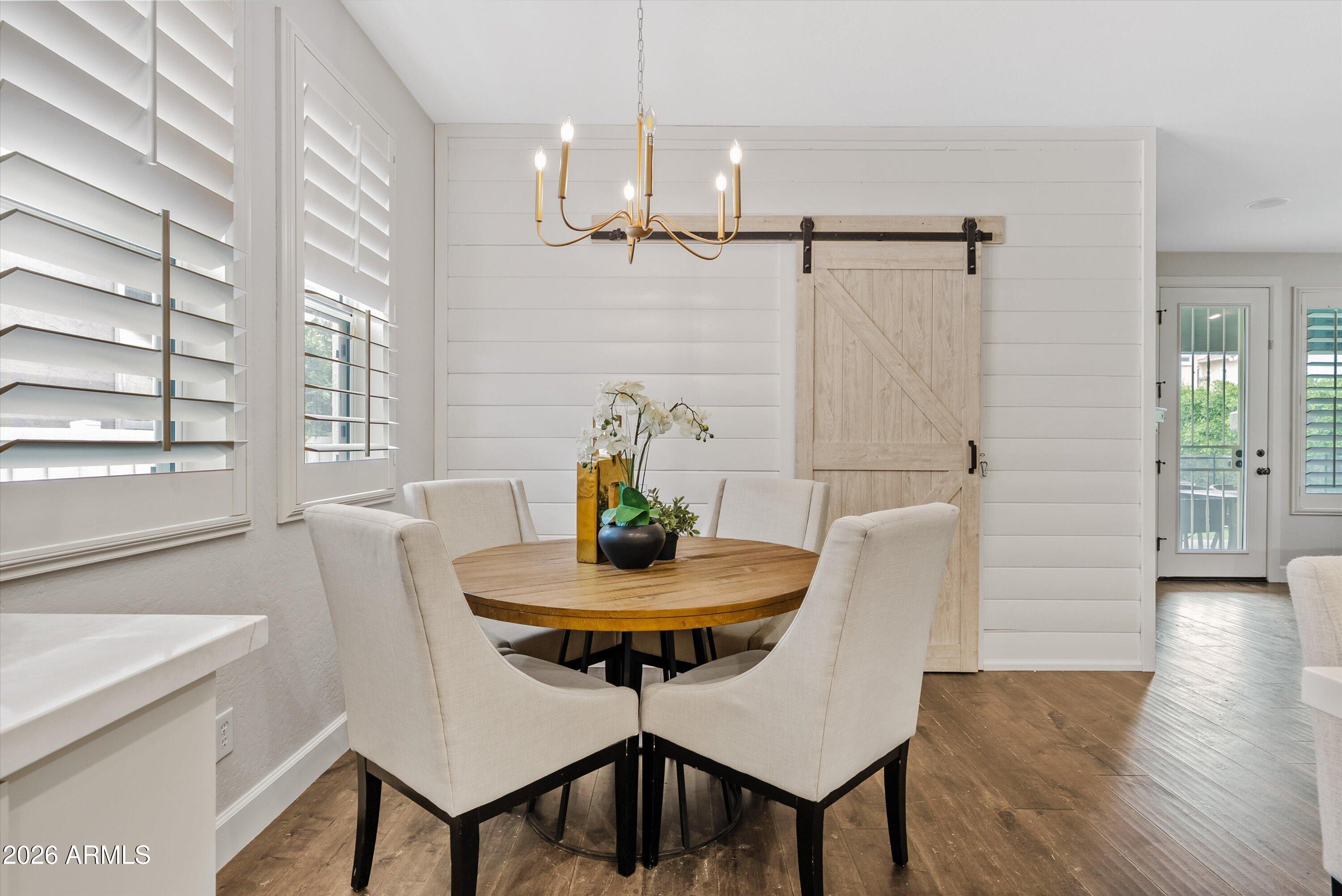 3112 East Agritopia Loop North Gilbert, AZ 85296 - Photo 15 of 40 a view of a dining room with furniture and wooden floor