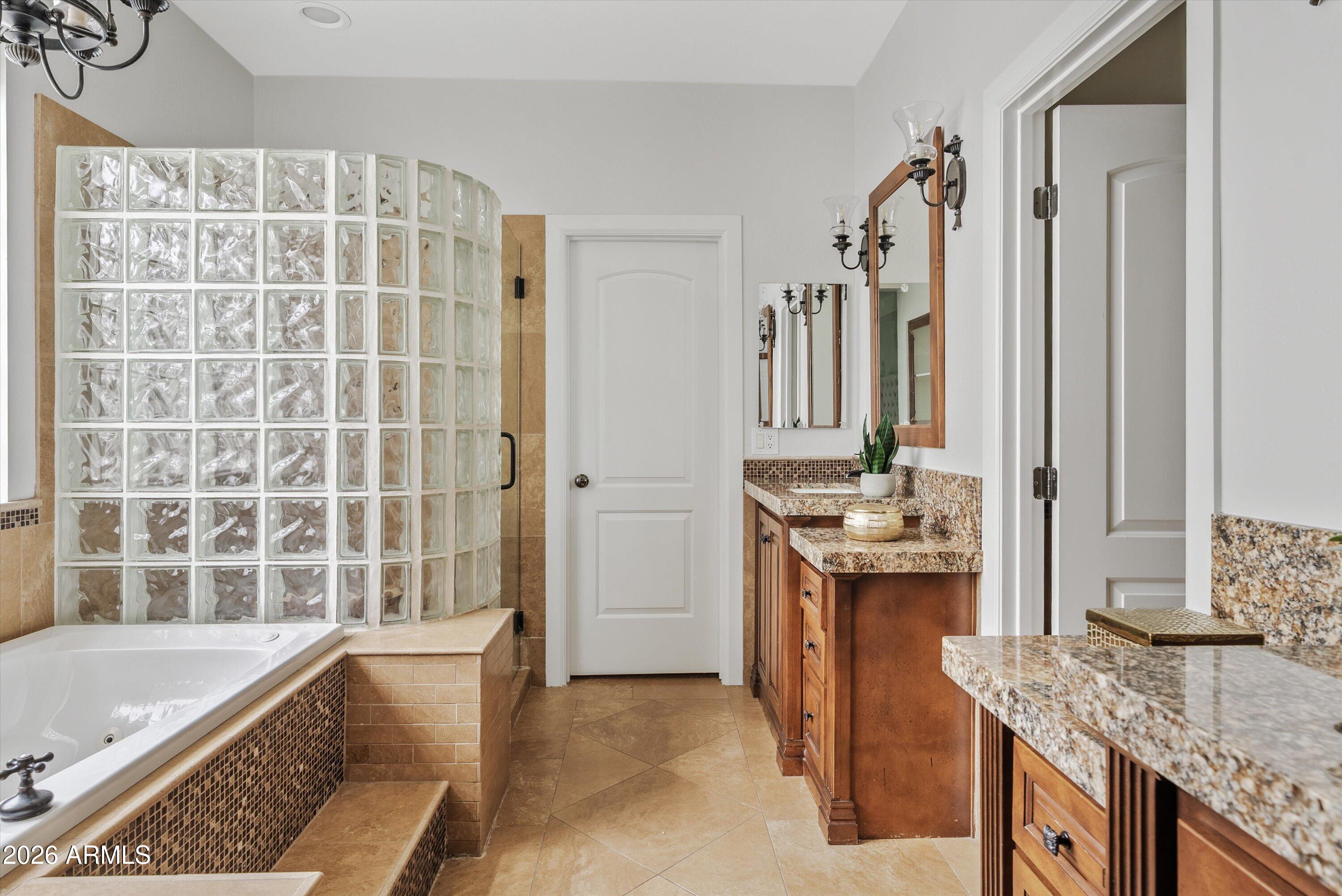 3112 East Agritopia Loop North Gilbert, AZ 85296 - Photo 22 of 40 a bathroom with a granite countertop sink and a bathtub