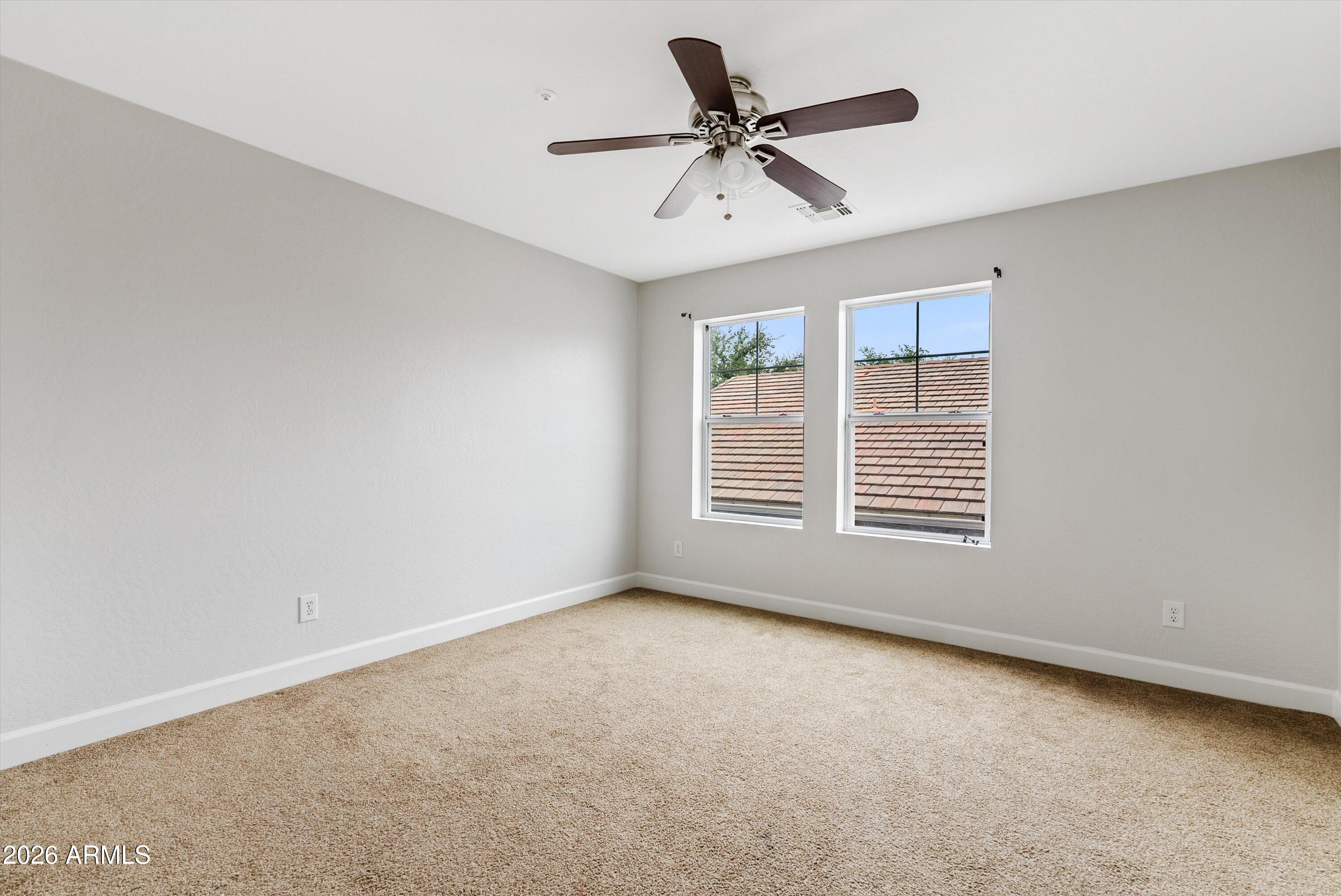 3112 East Agritopia Loop North Gilbert, AZ 85296 - Photo 27 of 40 a view of a livingroom with a ceiling fan and window