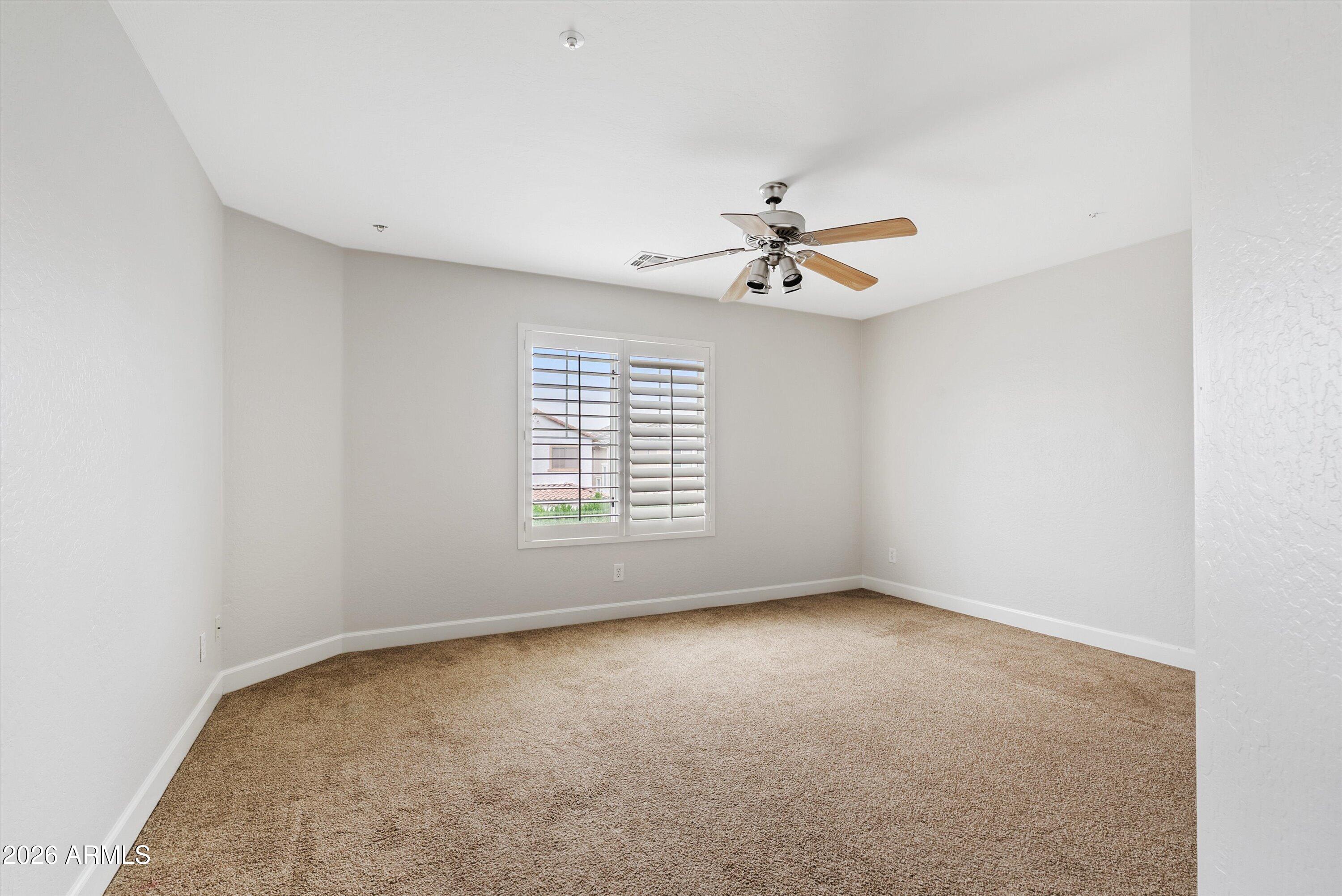 3112 East Agritopia Loop North Gilbert, AZ 85296 - Photo 29 of 40 an empty room with windows and fan