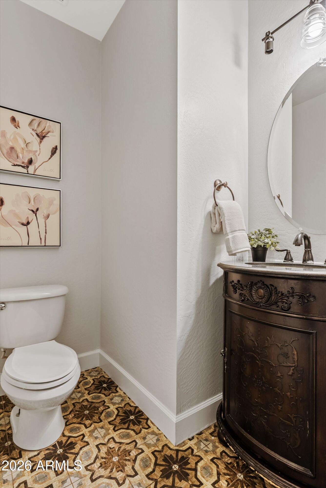 3112 East Agritopia Loop North Gilbert, AZ 85296 - Photo 34 of 40 a bathroom with a toilet and a sink