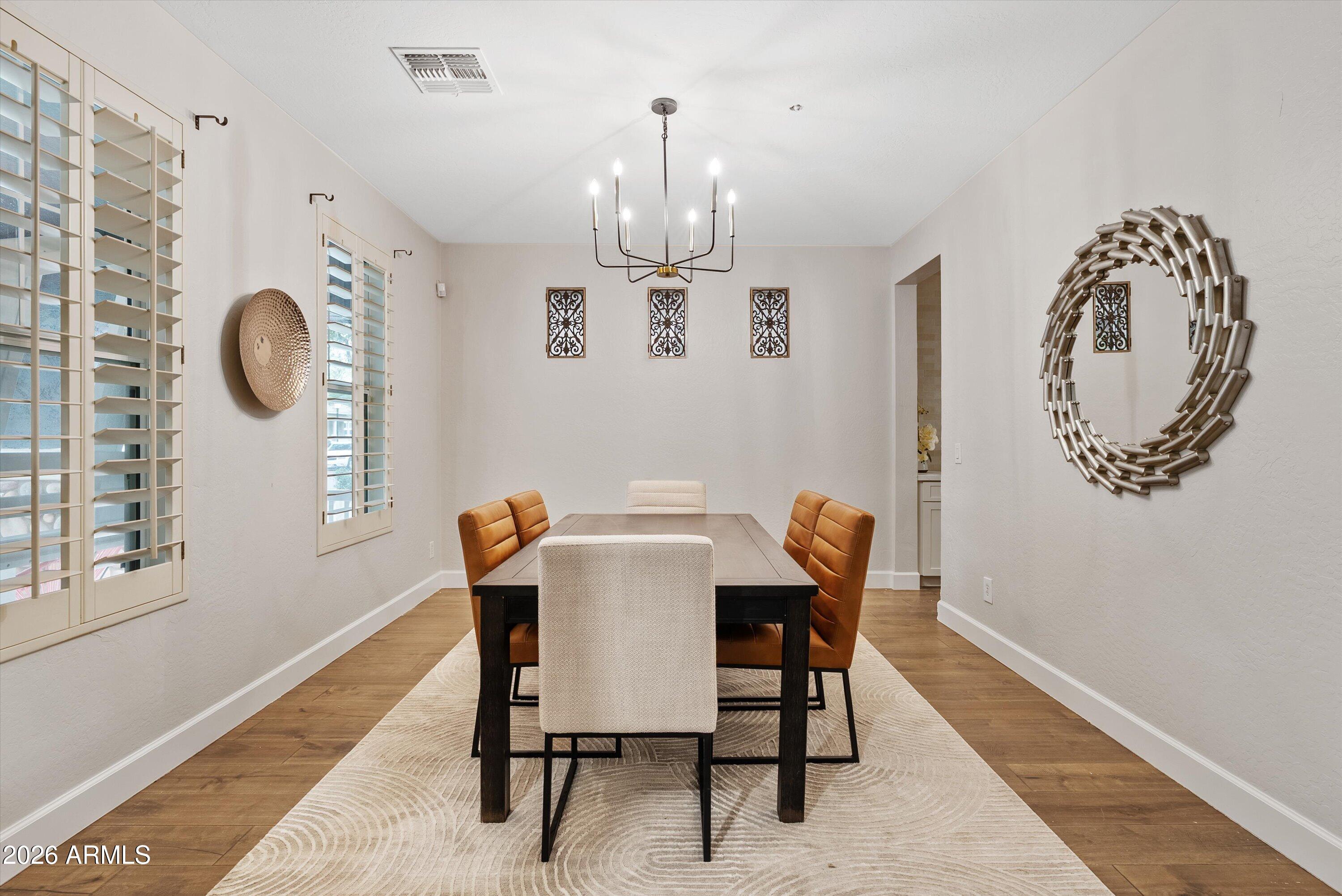 3112 East Agritopia Loop North Gilbert, AZ 85296 - Photo 6 of 40 a view of a dining room with furniture and chandelier