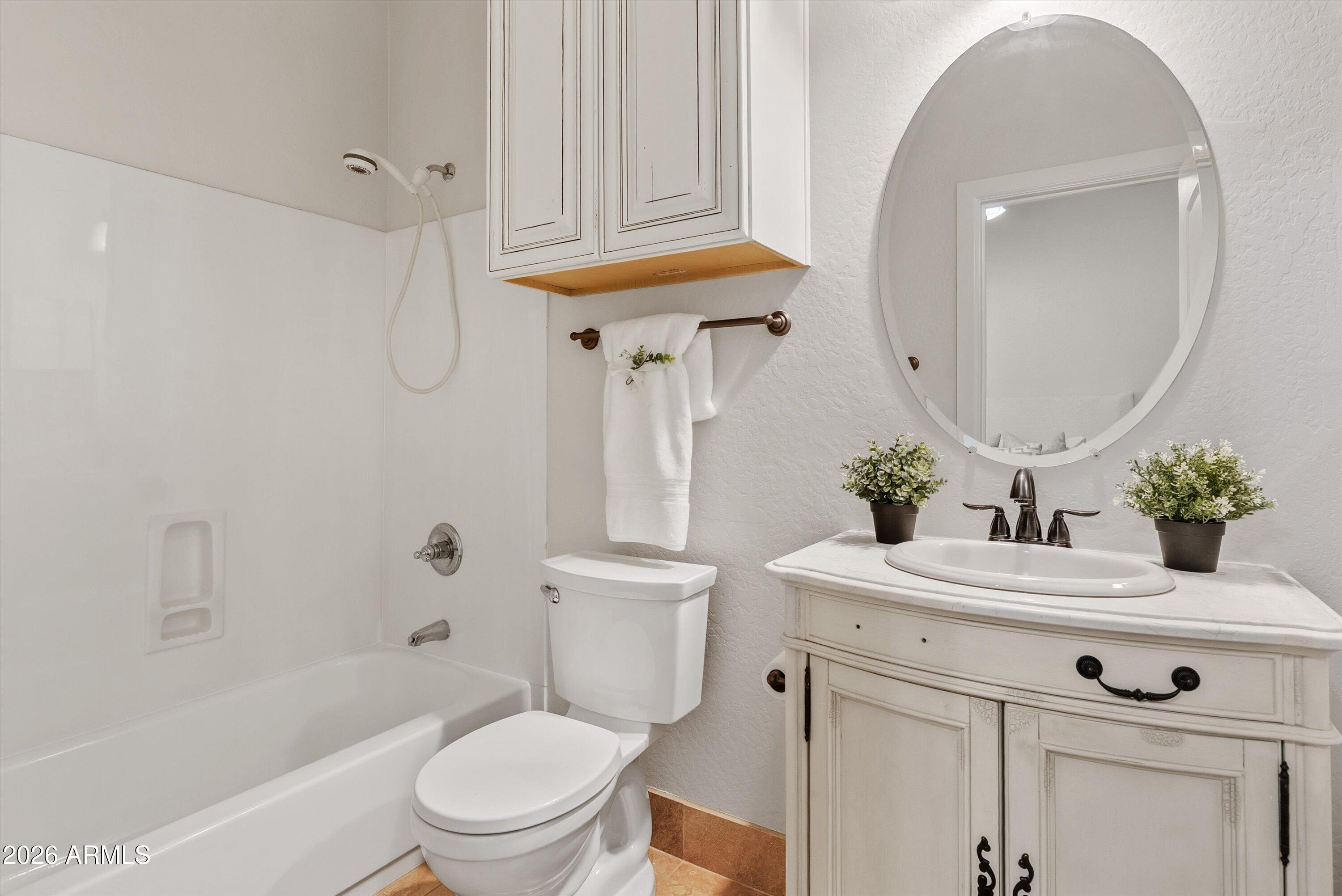 3112 East Agritopia Loop North Gilbert, AZ 85296 - Photo 9 of 40 a bathroom with a sink a toilet and a mirror