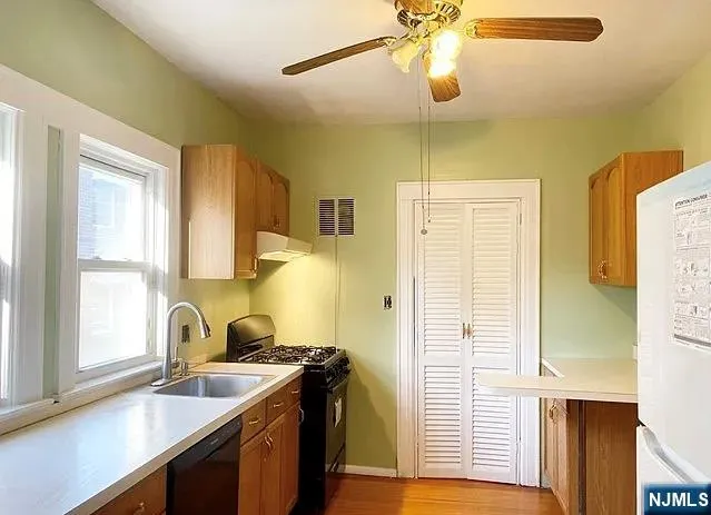 a kitchen with a sink a stove and a window