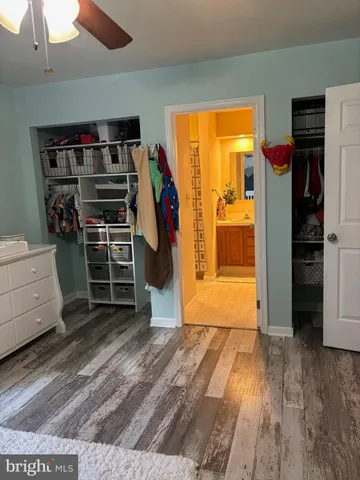 a view of empty room with wooden floor and closet