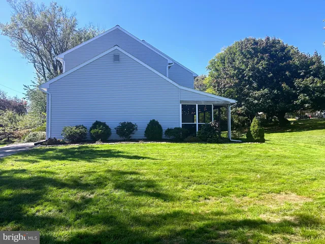 a view of a house with a yard and potted plants