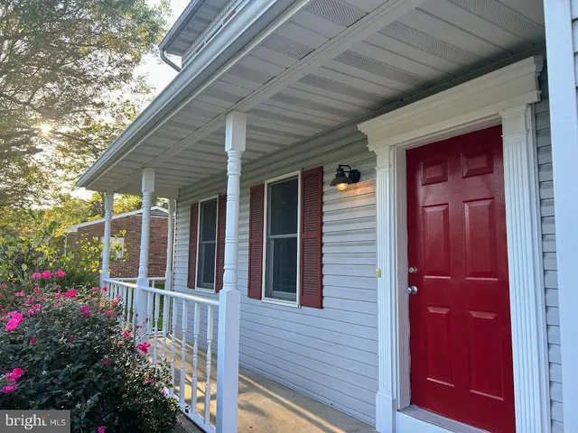 a view of a porch with a flower garden