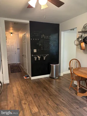 a view of a hallway with dining area