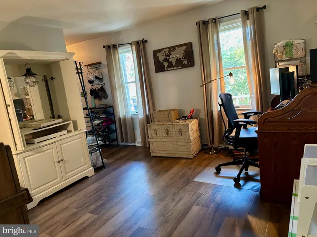 a view of a room with wooden floor and furniture