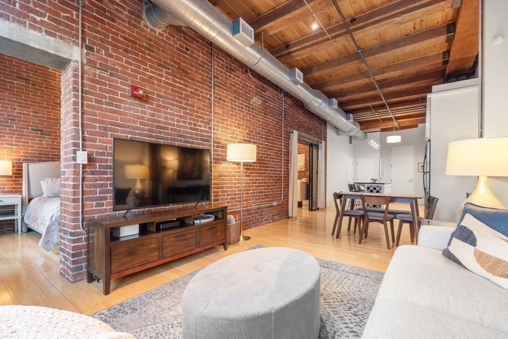 35 Channel Center Street, Unit 303 Boston, MA 02210 - Photo 11 of 28 a living room with furniture and a flat screen tv