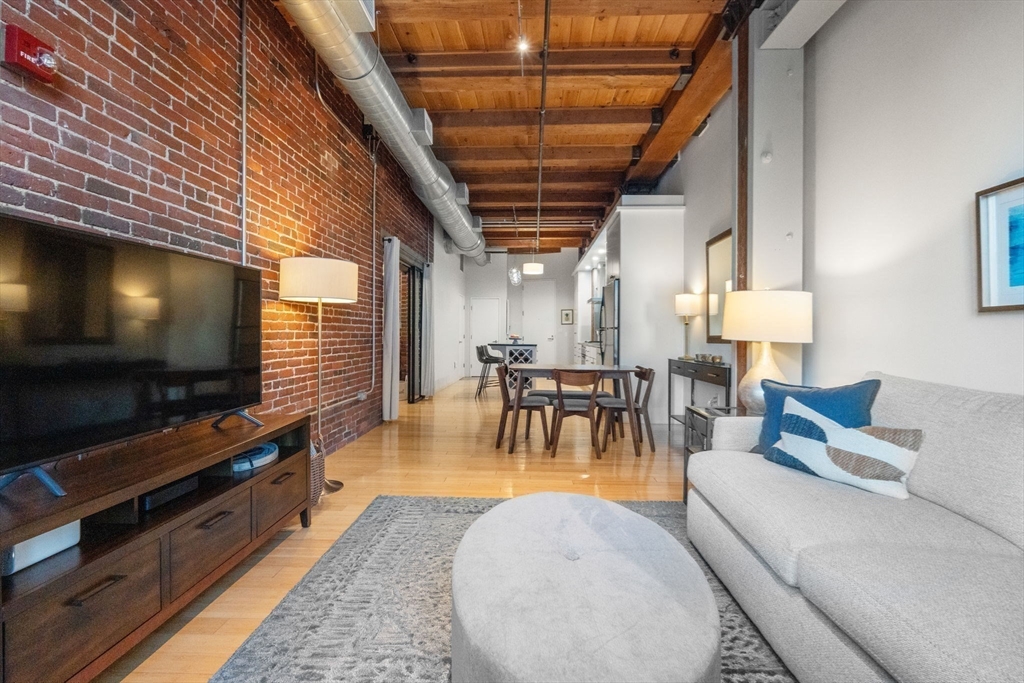 35 Channel Center Street, Unit 303 Boston, MA 02210 - Photo 10 of 28 a living room with furniture and a flat screen tv