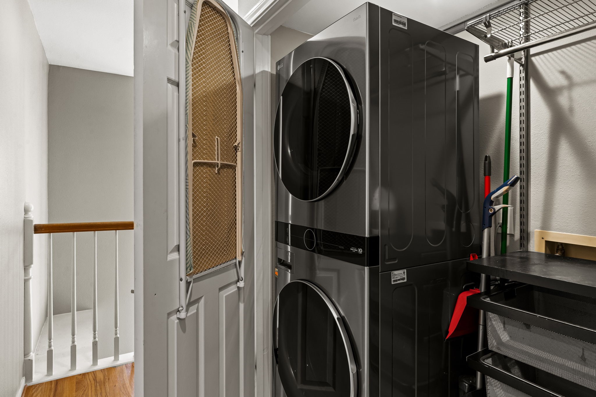 254 East 5th Street Houston, TX 77007 - Photo 17 of 31 A dedicated utility space offers full-size stacked laundry with additional shelving for storage and organization. Conveniently located and thoughtfully tucked away, it maximizes efficiency without sacrificing valuable living space.