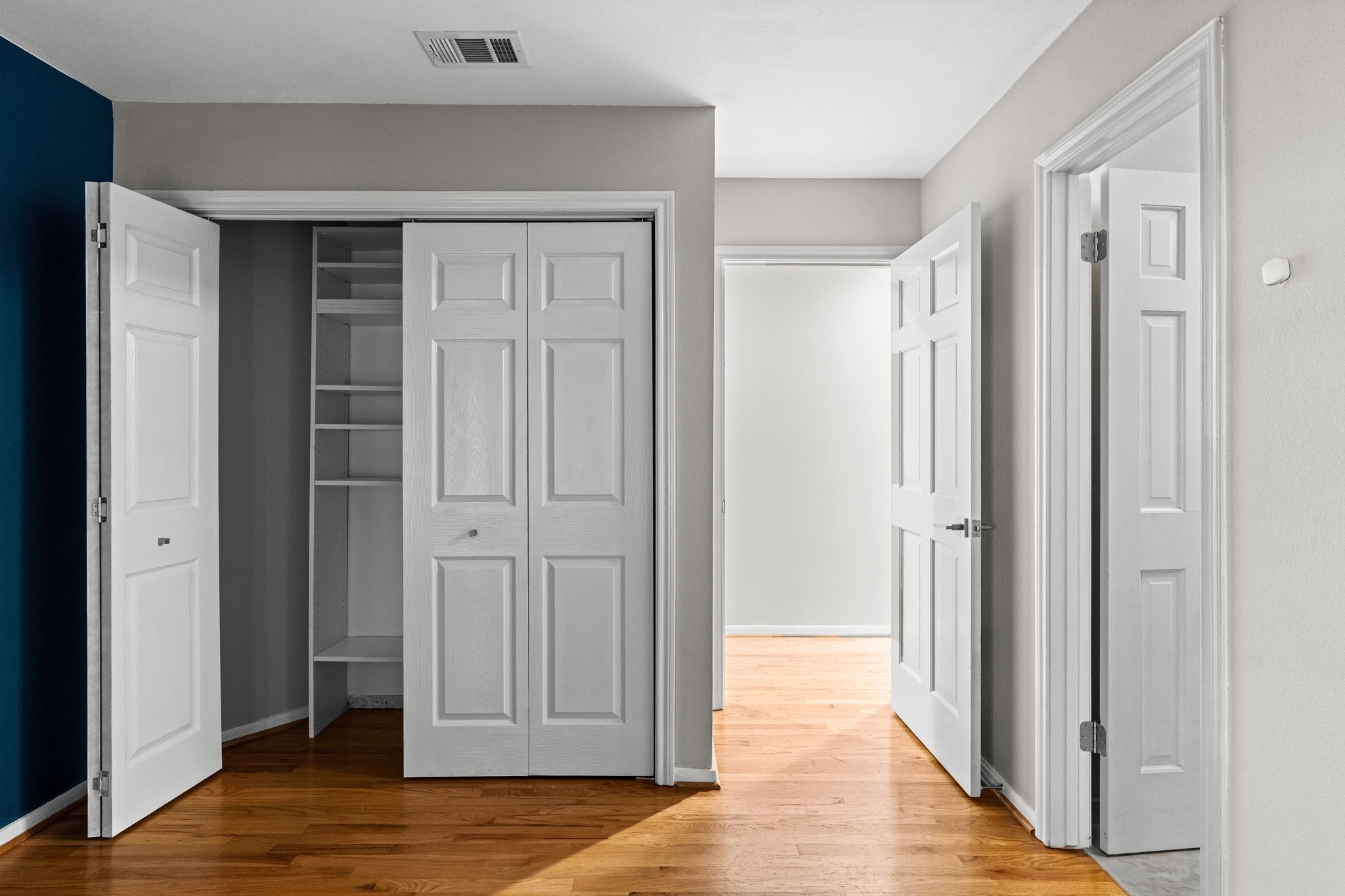 254 East 5th Street Houston, TX 77007 - Photo 20 of 31 Generous closet space provides built-in shelving and storage solutions for organization. The layout allows easy access to the ensuite bath, creating a comfortable and functional primary suite arrangement.
