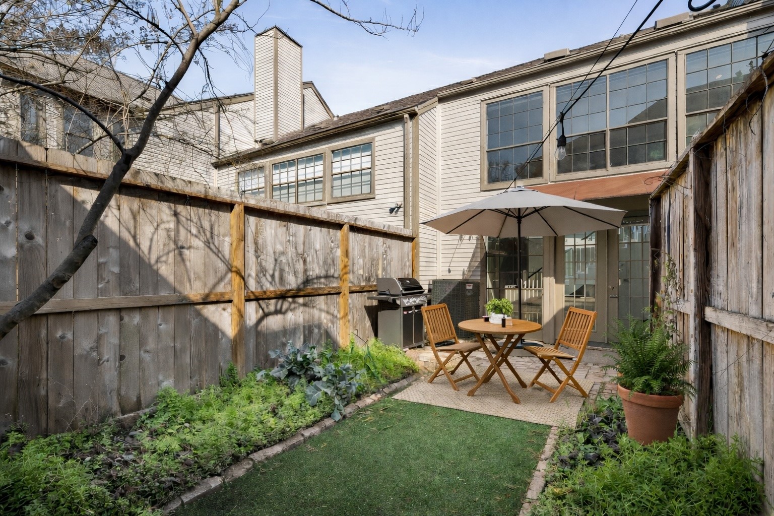254 East 5th Street Houston, TX 77007 - Photo 2 of 31 **Virtually Staged** The fenced backyard offers a rare private outdoor retreat in the heart of the Heights. Featuring low-maintenance turf, brick paver patio space, and perimeter planting beds, this yard is designed for easy enjoyment year-round.