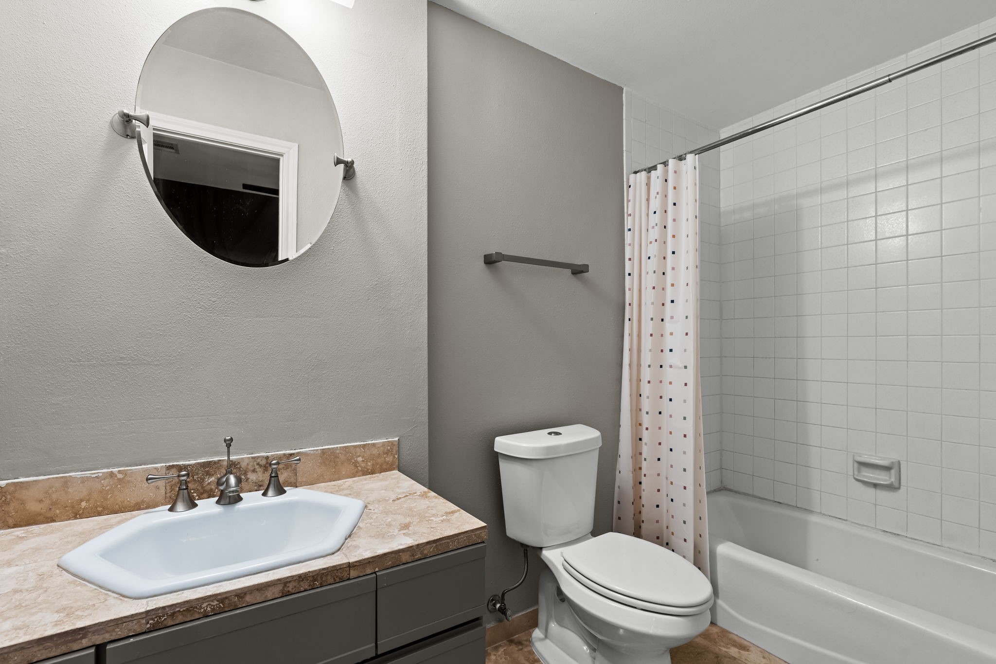 254 East 5th Street Houston, TX 77007 - Photo 21 of 31 The secondary bath includes a vanity with stone countertop and a full tub/shower combination. Neutral finishes and a practical layout provide comfort and convenience for guests or additional household members.