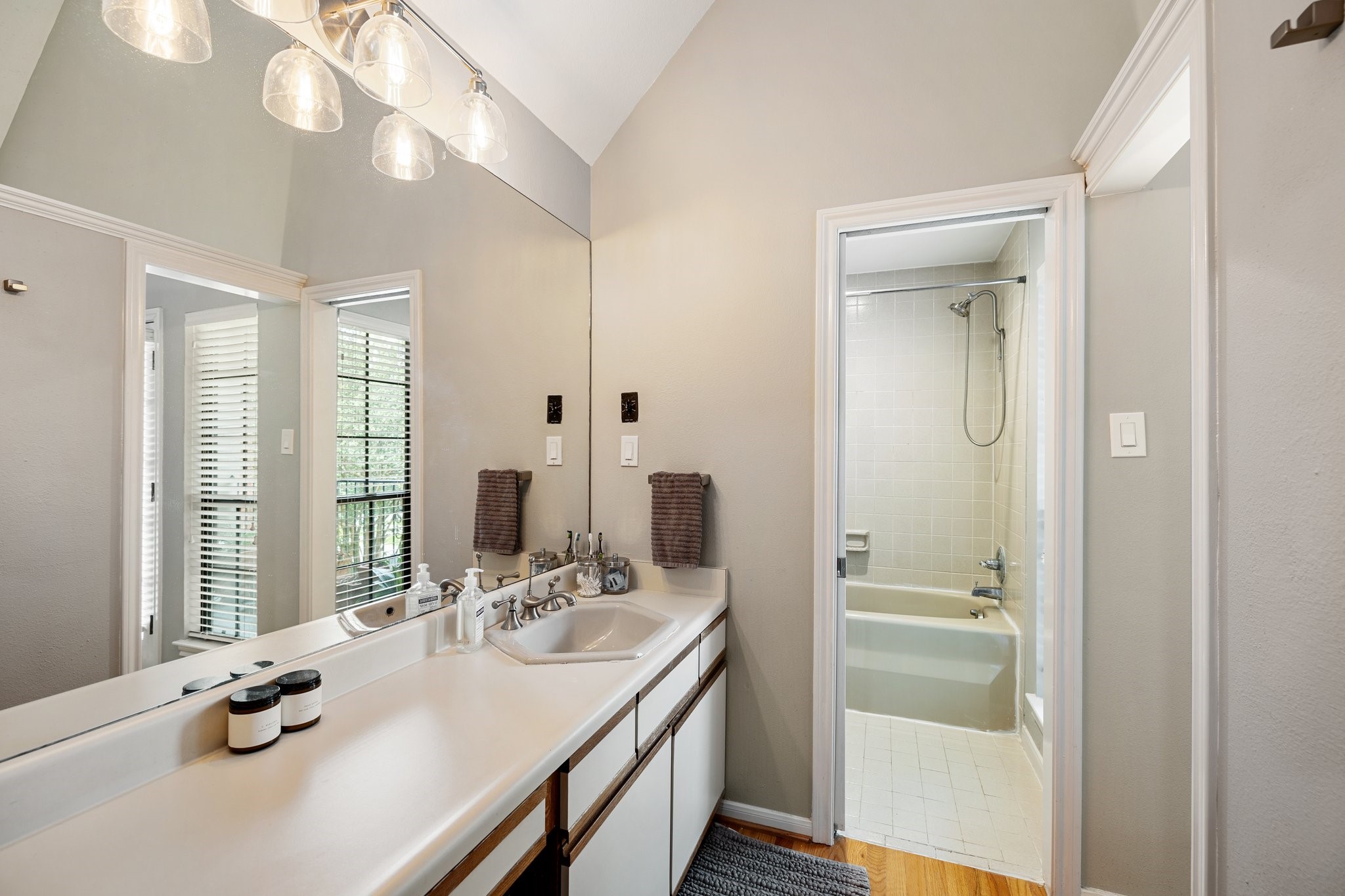 254 East 5th Street Houston, TX 77007 - Photo 24 of 40 a bathroom with a granite countertop sink a large mirror and a shower