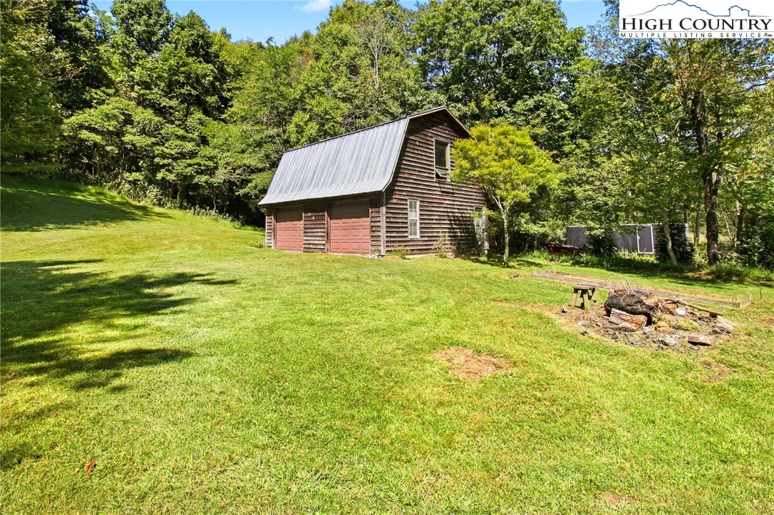 2166 George Hayes Road Boone, NC 28607 - Photo 16 of 50 a backyard of a house with large trees and plants