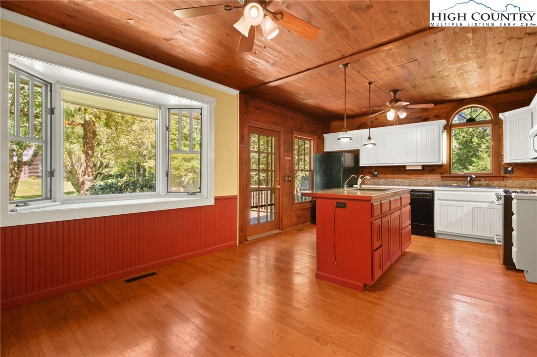 2166 George Hayes Road Boone, NC 28607 - Photo 22 of 50 a kitchen with stainless steel appliances granite countertop a stove and a wooden floors