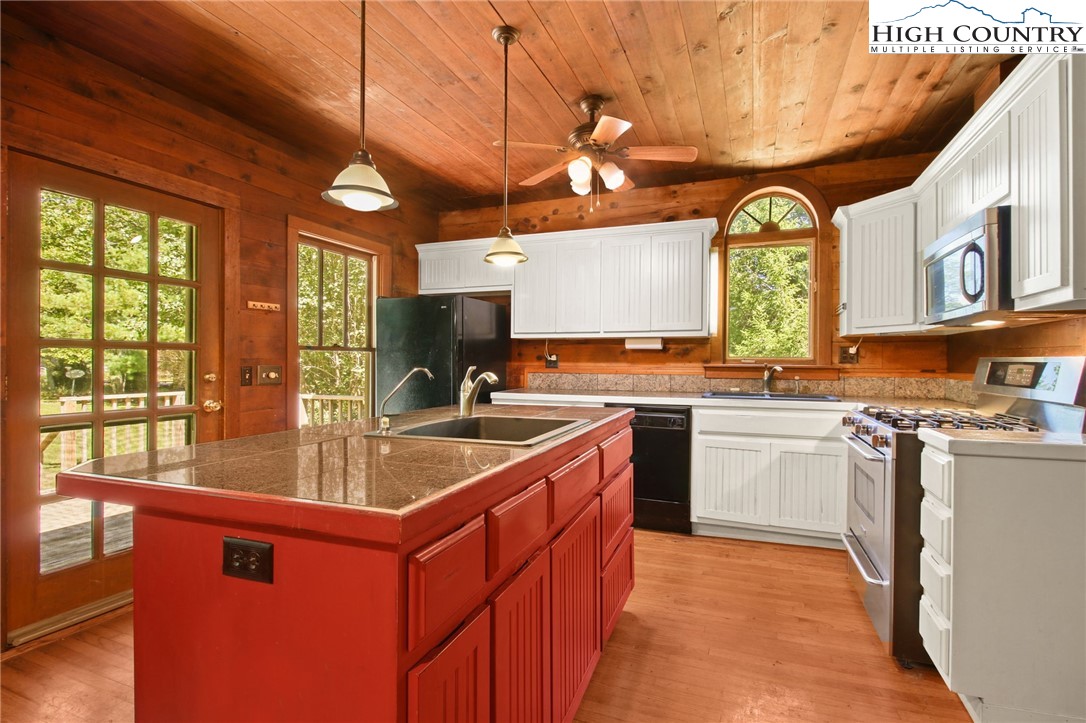 2166 George Hayes Road Boone, NC 28607 - Photo 24 of 50 a kitchen with stainless steel appliances granite countertop a sink stove and cabinets