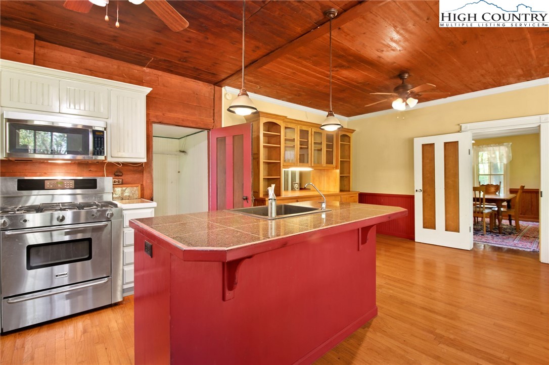2166 George Hayes Road Boone, NC 28607 - Photo 25 of 50 a kitchen with stainless steel appliances granite countertop a sink counter space and wooden floor