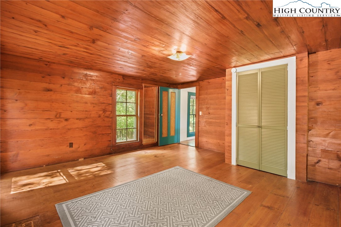 2166 George Hayes Road Boone, NC 28607 - Photo 43 of 50 an empty room with wooden floor and windows