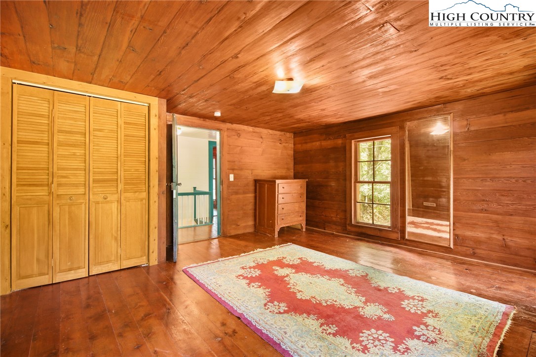 2166 George Hayes Road Boone, NC 28607 - Photo 46 of 50 a spacious bedroom with a bed and wooden floor
