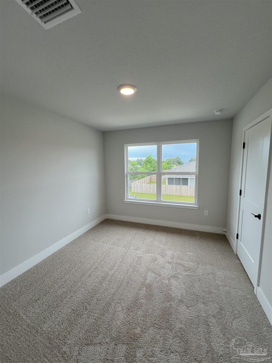 3339 Bliss Lane, Unit 9E Cantonment, FL 32533 - Photo 5 of 13 an empty room with windows