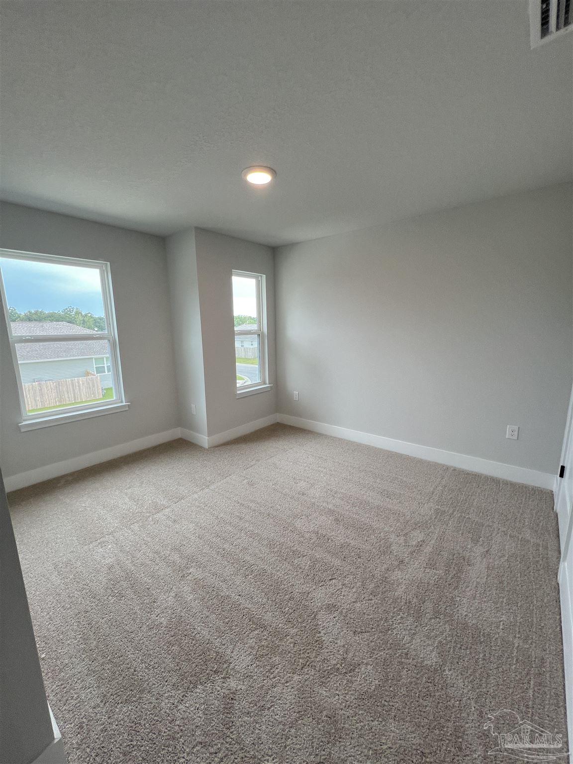 3339 Bliss Lane, Unit 9E Cantonment, FL 32533 - Photo 6 of 13 an empty room with windows