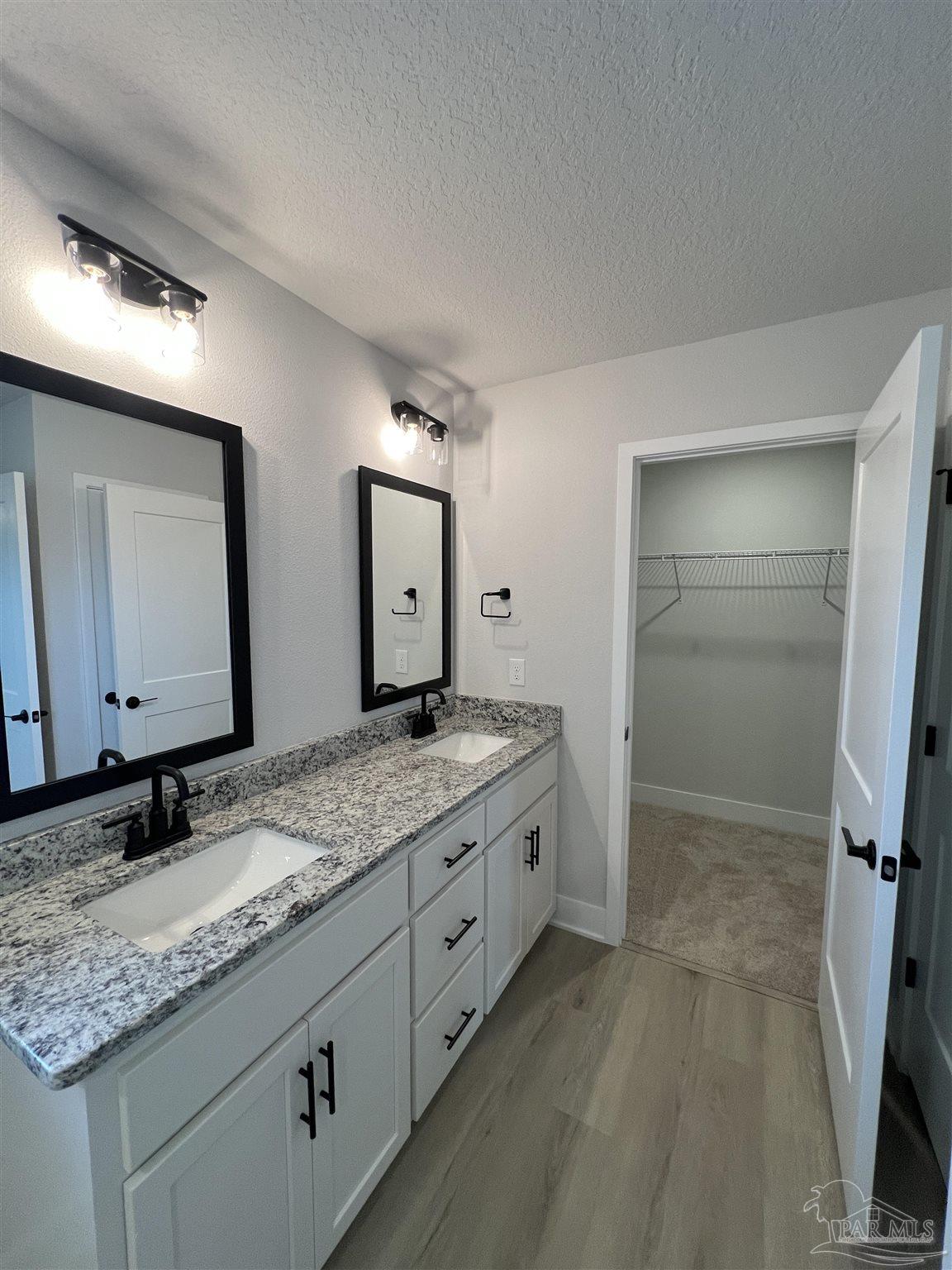 3339 Bliss Lane, Unit 9E Cantonment, FL 32533 - Photo 10 of 13 a bathroom with a granite countertop sink and a mirror