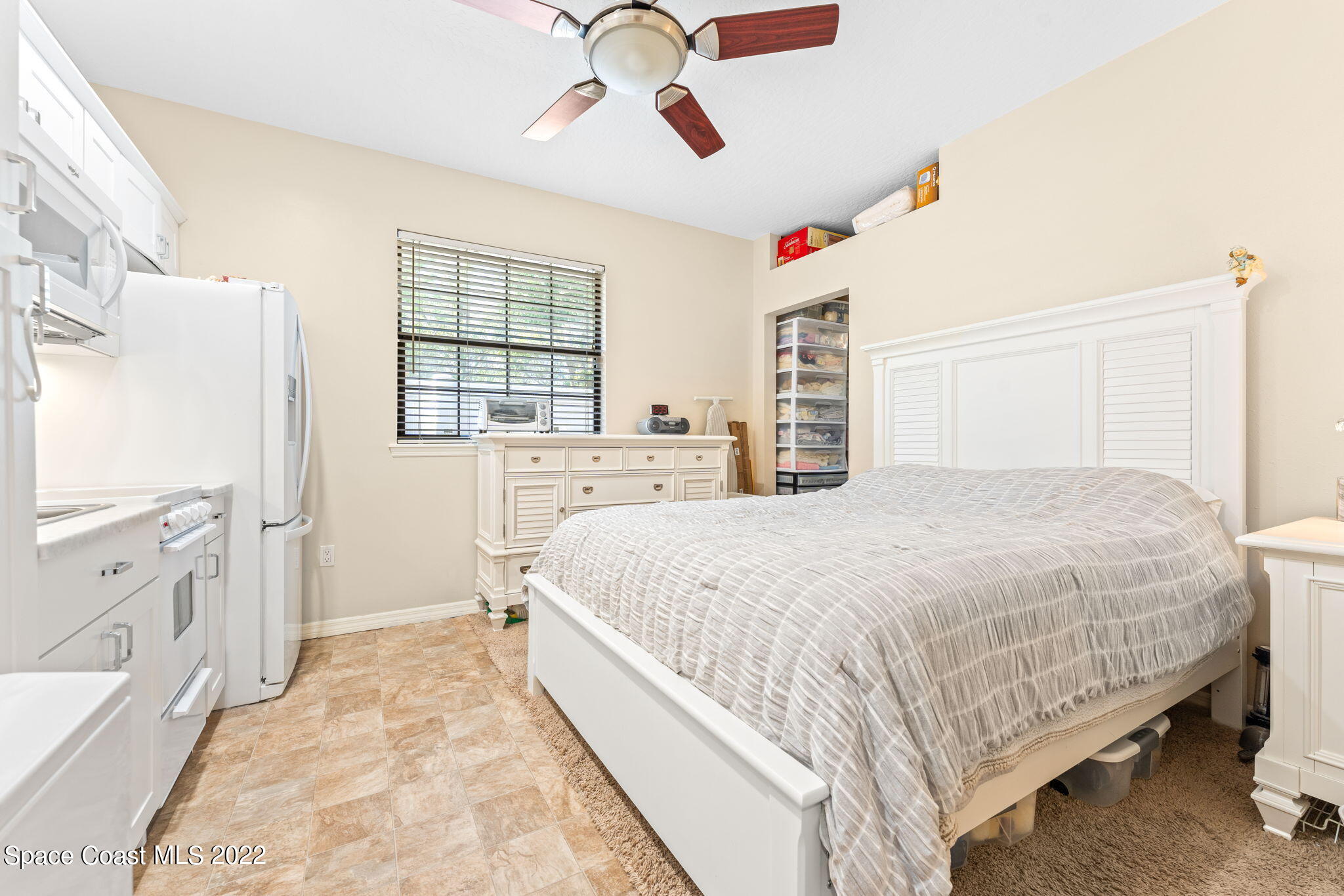 4668 Canard Road Melbourne, FL 32934 - Photo 14 of 29 a spacious bedroom with a bed and a dresser