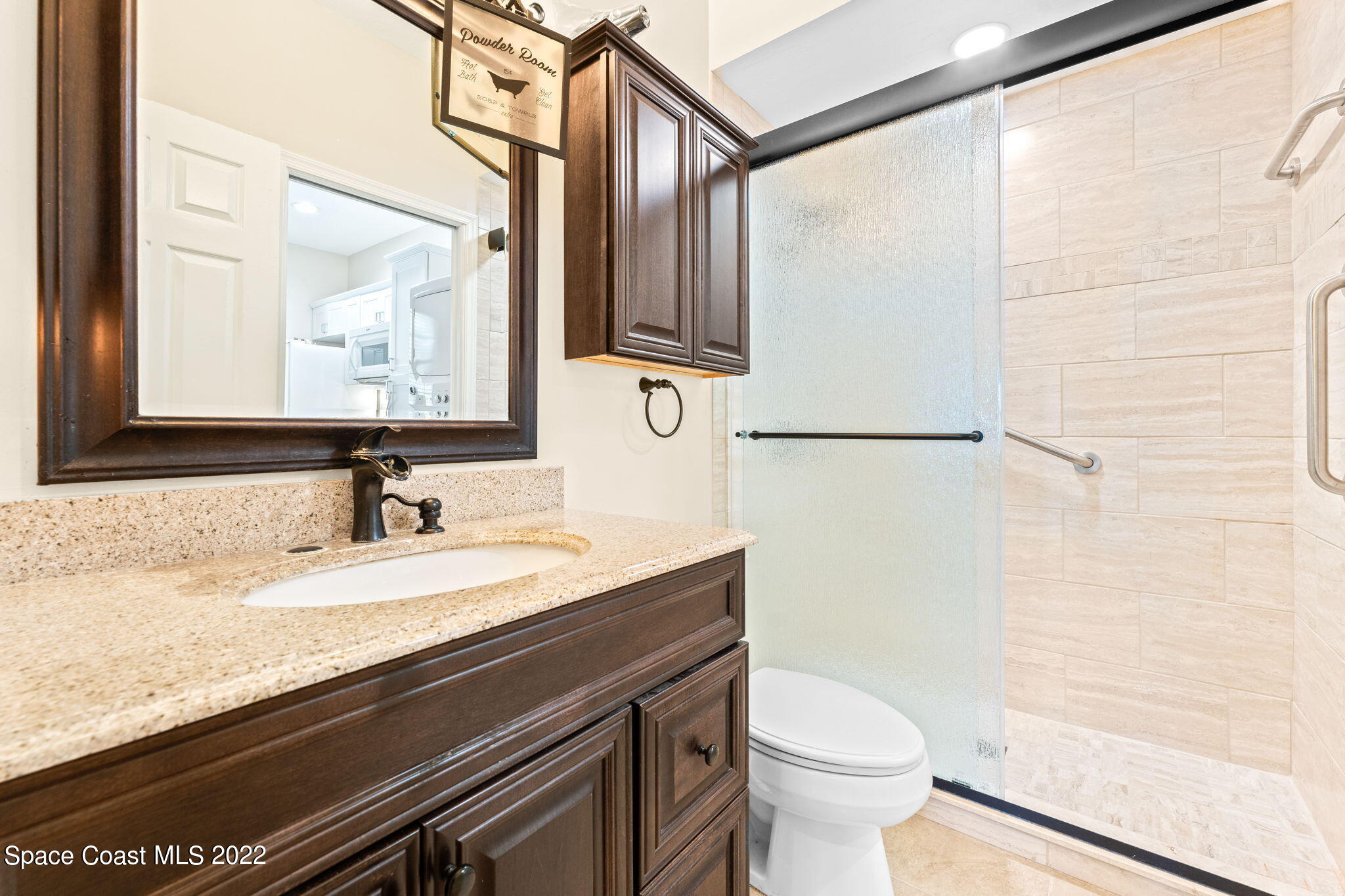 4668 Canard Road Melbourne, FL 32934 - Photo 16 of 29 a bathroom with a granite countertop sink toilet and a mirror