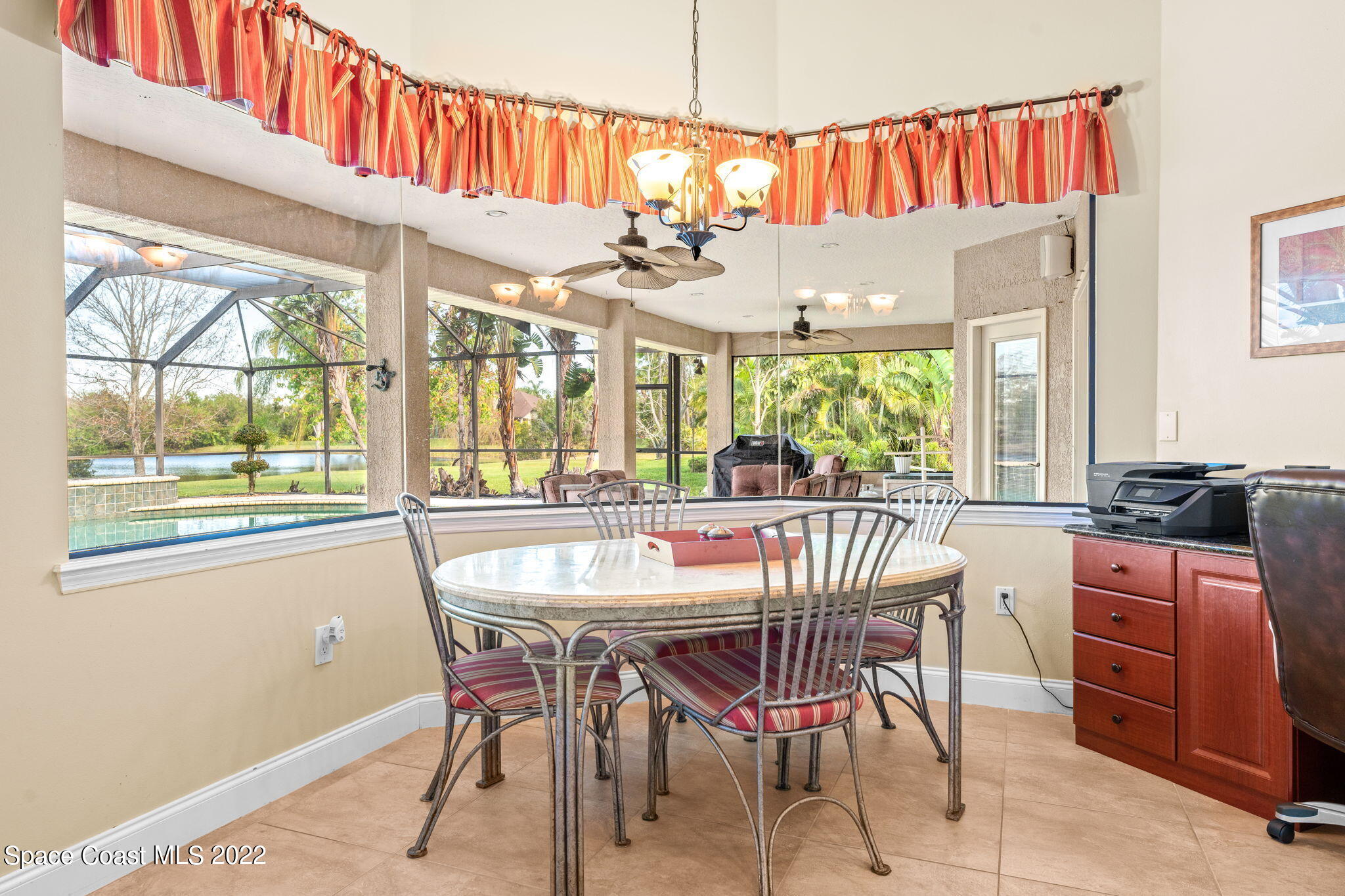 4668 Canard Road Melbourne, FL 32934 - Photo 4 of 29 a dining room with furniture a chandelier and window
