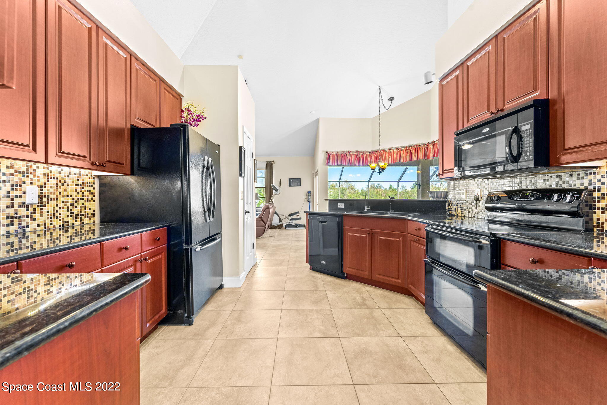 4668 Canard Road Melbourne, FL 32934 - Photo 6 of 29 a kitchen with stainless steel appliances kitchen island granite countertop a stove a refrigerator and a sink