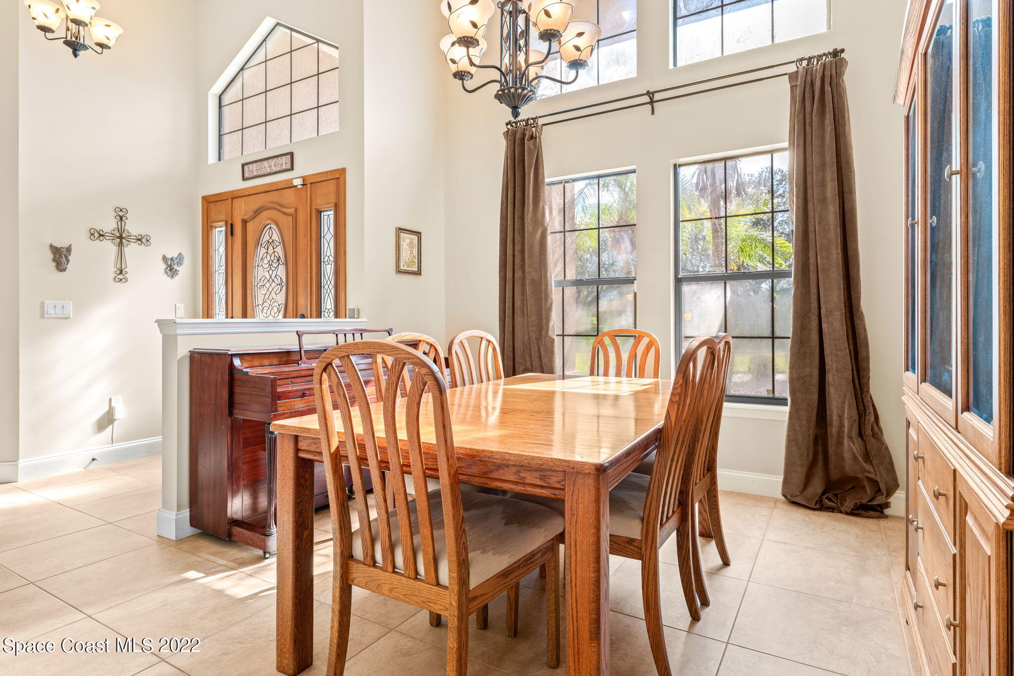 4668 Canard Road Melbourne, FL 32934 - Photo 7 of 29 a view of a dining room with furniture and chandelier