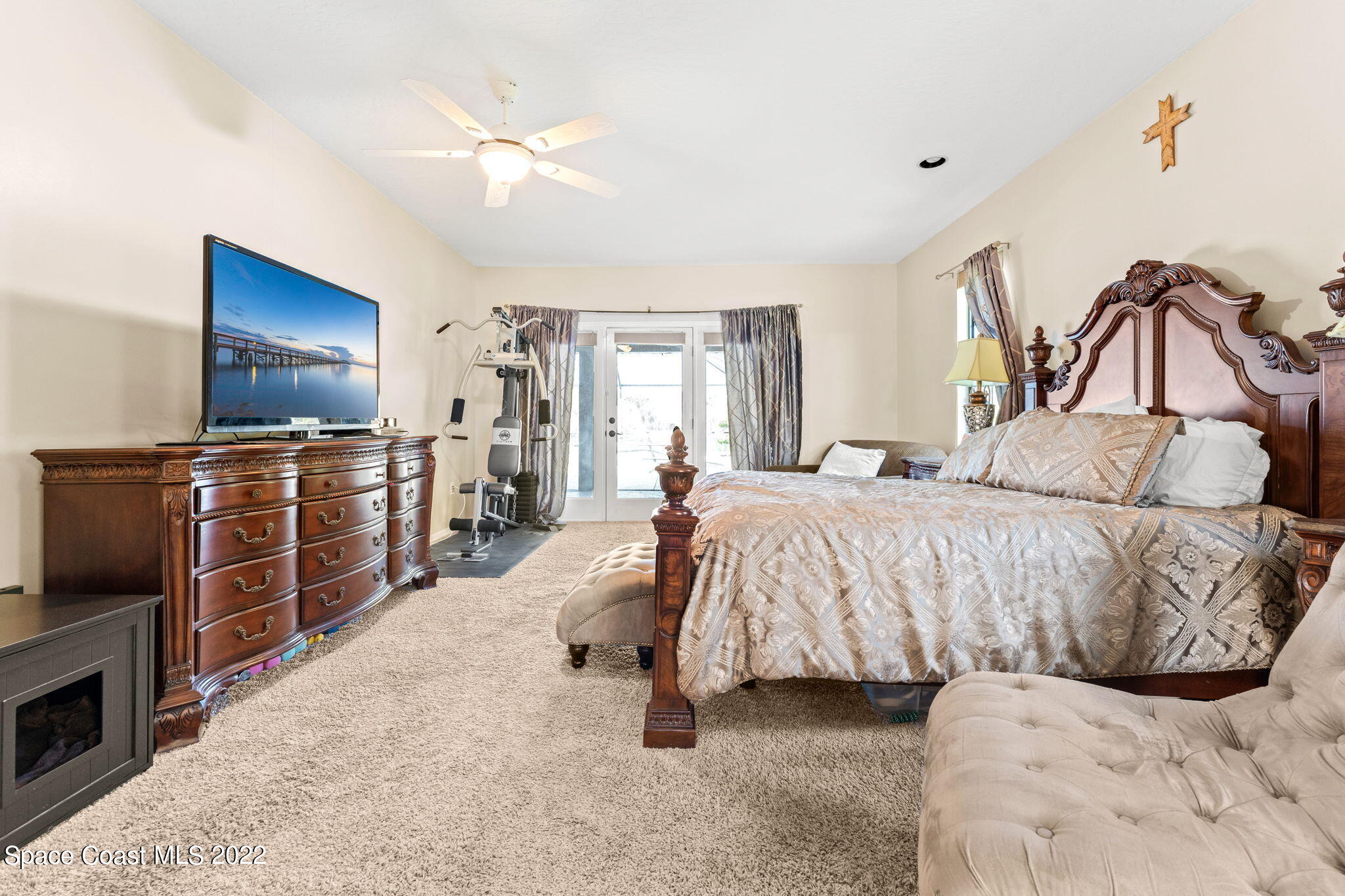 4668 Canard Road Melbourne, FL 32934 - Photo 8 of 29 a bedroom with a bed and a television