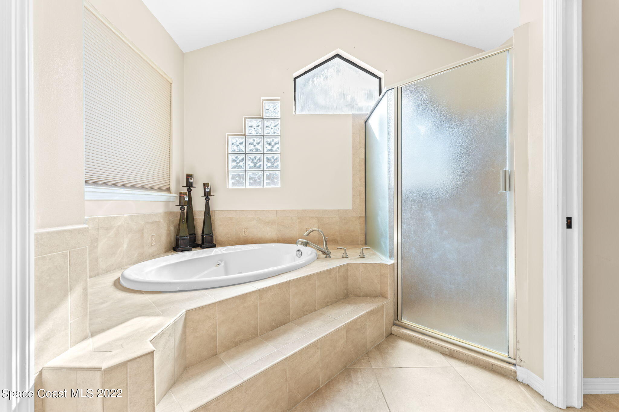 4668 Canard Road Melbourne, FL 32934 - Photo 9 of 29 a bathroom with a sink a toilet and shower