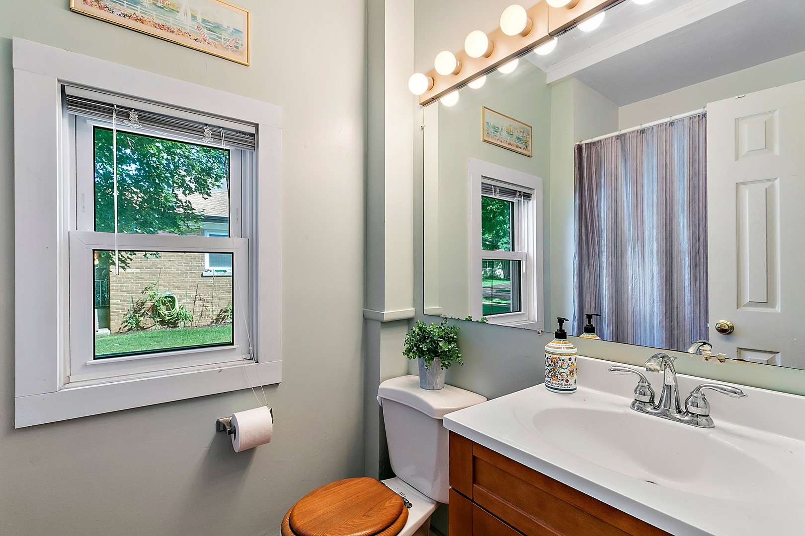 169 Barrypoint Road Riverside, IL 60546 - Photo 7 of 27 a bathroom with a sink vanity granite toilet and a mirror