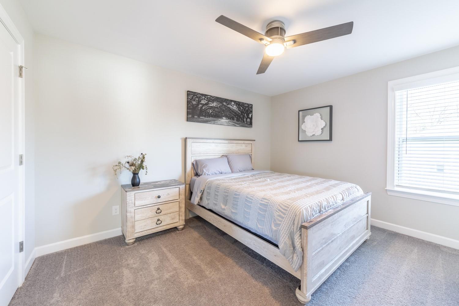 1280 West Rebound Road Lancaster, SC 29720 - Photo 25 of 34 a bedroom with a bed and a chandelier fan